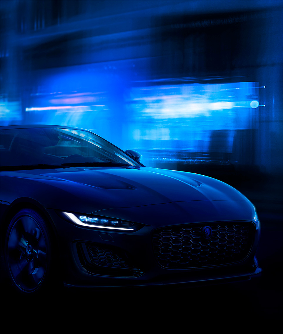 Front view of Jaguar at night with blue background